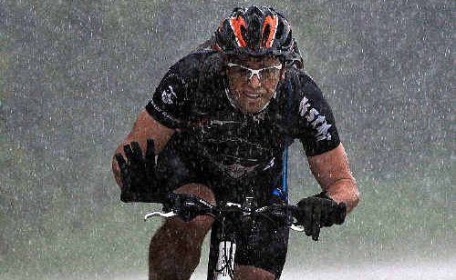 Hell on Wheels rider Michael Brown managed a rain-drenched wave as he approaches Bellingen. Hell on Wheels rider Michael Brown managed a rain-drenched wave as he approaches Bellingen.